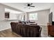 Inviting living room with a sectional sofa, TV, ceiling fan, and hardwood floors at 6463 Wasco Dr, Whitestown, IN 46075