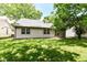 Beautiful backyard showcasing a well-manicured lawn, a patio, and the house's exterior under a bright sky at 6471 Hunters Green Pl, Indianapolis, IN 46278