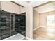 Bathroom with modern shower stall and dark marble tile, and doorway to bedroom at 6471 Hunters Green Pl, Indianapolis, IN 46278