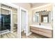 Bathroom with modern vanity, lighting, and glass enclosed shower with black marble tiles at 6471 Hunters Green Pl, Indianapolis, IN 46278