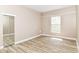 Bedroom with closet, wood-look flooring and neutral colored walls at 6471 Hunters Green Pl, Indianapolis, IN 46278