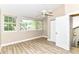Bedroom with wood-look flooring, a fan, and a set of windows providing great natural light and views at 6471 Hunters Green Pl, Indianapolis, IN 46278