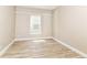 Bedroom with wood-look flooring, white trim and neutral colored walls at 6471 Hunters Green Pl, Indianapolis, IN 46278