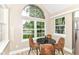 Bright breakfast nook featuring a round table and chairs, large windows, and modern decor elements at 6471 Hunters Green Pl, Indianapolis, IN 46278