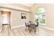 Bright dining area with vaulted ceilings, large windows, and stylish modern furnishings at 6471 Hunters Green Pl, Indianapolis, IN 46278
