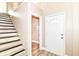 Bright entryway features wood floors, stairs with black accents, and a front door with decorative glass detailing at 6471 Hunters Green Pl, Indianapolis, IN 46278