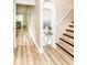 Inviting hallway with wood flooring and modern staircase leading to the upper level at 6471 Hunters Green Pl, Indianapolis, IN 46278
