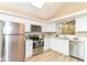 Bright modern kitchen featuring white cabinets, stainless steel appliances, and sleek countertops at 6471 Hunters Green Pl, Indianapolis, IN 46278