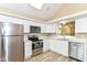 Bright kitchen with stainless steel appliances, white cabinets and a skylight at 6471 Hunters Green Pl, Indianapolis, IN 46278