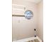 Laundry room with open shelving and a decorative round window at 6471 Hunters Green Pl, Indianapolis, IN 46278