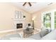 Cozy living room featuring a fireplace, vaulted ceiling, and access to outdoor patio at 6471 Hunters Green Pl, Indianapolis, IN 46278