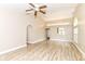 Open living room boasts vaulted ceilings, wood floors, and a pass-through to the kitchen at 6471 Hunters Green Pl, Indianapolis, IN 46278