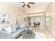 Open-concept living room with vaulted ceilings, dining area, and comfortable gray seating at 6471 Hunters Green Pl, Indianapolis, IN 46278