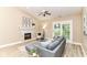 Comfortable living room featuring a fireplace, vaulted ceiling and access to outdoor patio at 6471 Hunters Green Pl, Indianapolis, IN 46278