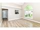 Inviting living room with an arched window, pass-through to the kitchen, and neutral wall color at 6471 Hunters Green Pl, Indianapolis, IN 46278