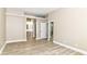 Spacious main bedroom, neutral walls and wood-look floors, leading to bathroom at 6471 Hunters Green Pl, Indianapolis, IN 46278