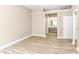Spacious main bedroom, neutral walls and wood-look floors, leading to bathroom at 6471 Hunters Green Pl, Indianapolis, IN 46278