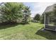 Sprawling backyard with mature trees and a screened-in patio for outdoor enjoyment at 6542 E Edna Mills Dr, Camby, IN 46113