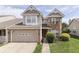 Charming two-story home with a brick-accented facade, a two-car garage, and mature landscaping at 6542 E Edna Mills Dr, Camby, IN 46113