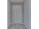 Clean foyer with neutral gray walls, tiled floors, and a white paneled front door at 6542 E Edna Mills Dr, Camby, IN 46113