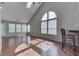 Bright, open living room with hardwood floors, skylight, and large arched window at 6542 E Edna Mills Dr, Camby, IN 46113