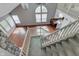 Bright open-concept living area boasts wood floors, fireplace, and stairs leading up to the loft at 6542 E Edna Mills Dr, Camby, IN 46113