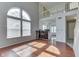 Bright open-concept living area features hardwood floors, a large window, and an adjacent kitchen at 6542 E Edna Mills Dr, Camby, IN 46113