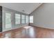 Bright living room with vaulted ceiling, wood floors, and abundant natural light from multiple windows at 6542 E Edna Mills Dr, Camby, IN 46113