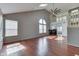 Airy living room with vaulted ceiling, hardwood floors, skylight, and large arched window at 6542 E Edna Mills Dr, Camby, IN 46113