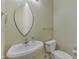 This powder room features a pedestal sink, sleek mirror, and modern fixtures at 6542 E Edna Mills Dr, Camby, IN 46113
