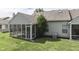 View of the screened porch, siding, and greenery of this lovely home at 6542 E Edna Mills Dr, Camby, IN 46113