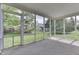 Screened-in porch with concrete floor, offering views of the backyard at 6542 E Edna Mills Dr, Camby, IN 46113