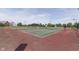 Outdoor tennis courts in a community setting with green surroundings and residential buildings at 6542 E Edna Mills Dr, Camby, IN 46113