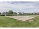 A community sand volleyball court surrounded by lush green grass and nearby homes at 6542 E Edna Mills Dr, Camby, IN 46113