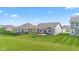 Spacious backyard with green grass, patio, grill, and exterior view of house at 6609 Dunkirk Dr, McCordsville, IN 46055