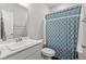 Bright bathroom featuring a shower with blue patterned curtain and a white vanity at 6609 Dunkirk Dr, McCordsville, IN 46055
