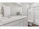 Bright bathroom featuring a double vanity with quartz countertops and tiled shower at 6609 Dunkirk Dr, McCordsville, IN 46055