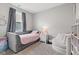 Charming bedroom with a cozy bed, seating and natural light at 6609 Dunkirk Dr, McCordsville, IN 46055