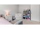 Bright bedroom space with shelving, cozy chair, and plenty of natural light at 6609 Dunkirk Dr, McCordsville, IN 46055
