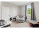 Bright bedroom with a comfortable chair, window view, and neutral colors at 6609 Dunkirk Dr, McCordsville, IN 46055
