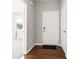 Bright foyer featuring wood floors, white walls, and an entry to another room at 6609 Dunkirk Dr, McCordsville, IN 46055