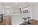 Open-concept kitchen featuring modern stools, breakfast bar and view to living area at 6609 Dunkirk Dr, McCordsville, IN 46055