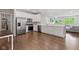 Contemporary kitchen featuring stainless steel appliances, wooden floors, and a breakfast bar at 6609 Dunkirk Dr, McCordsville, IN 46055