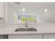 Modern kitchen sink with stainless steel faucet, with views to the living room at 6609 Dunkirk Dr, McCordsville, IN 46055