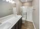 Bathroom featuring double sinks, vanity, and a glass-enclosed shower at 6847 Cardiff Dr, McCordsville, IN 46055