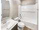 Bathroom featuring a sink with solid surface countertop, a toilet, and a tub with a shower at 6847 Cardiff Dr, McCordsville, IN 46055