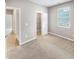 Bedroom showcasing neutral-colored walls, soft carpeting, closet, and multiple entryways at 6847 Cardiff Dr, McCordsville, IN 46055