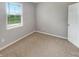 Comfortable bedroom featuring neutral walls, soft carpeting, and an exterior window at 6847 Cardiff Dr, McCordsville, IN 46055