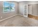 Bright bedroom featuring neutral walls, plush carpeting, and an exterior window with a neighborhood view at 6847 Cardiff Dr, McCordsville, IN 46055