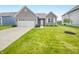 Charming single-Gathering home featuring a two-car garage, well-maintained lawn, and inviting front entrance at 6847 Cardiff Dr, McCordsville, IN 46055